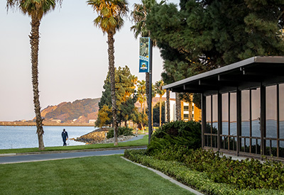 Library and water with student walking in background