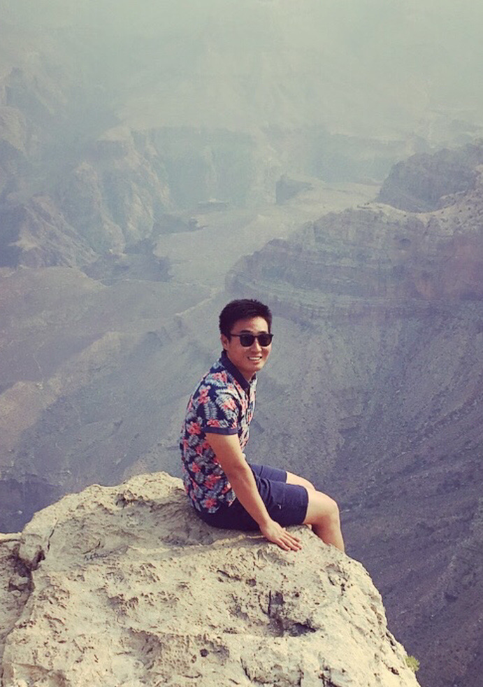 Young man sitting on the mountain